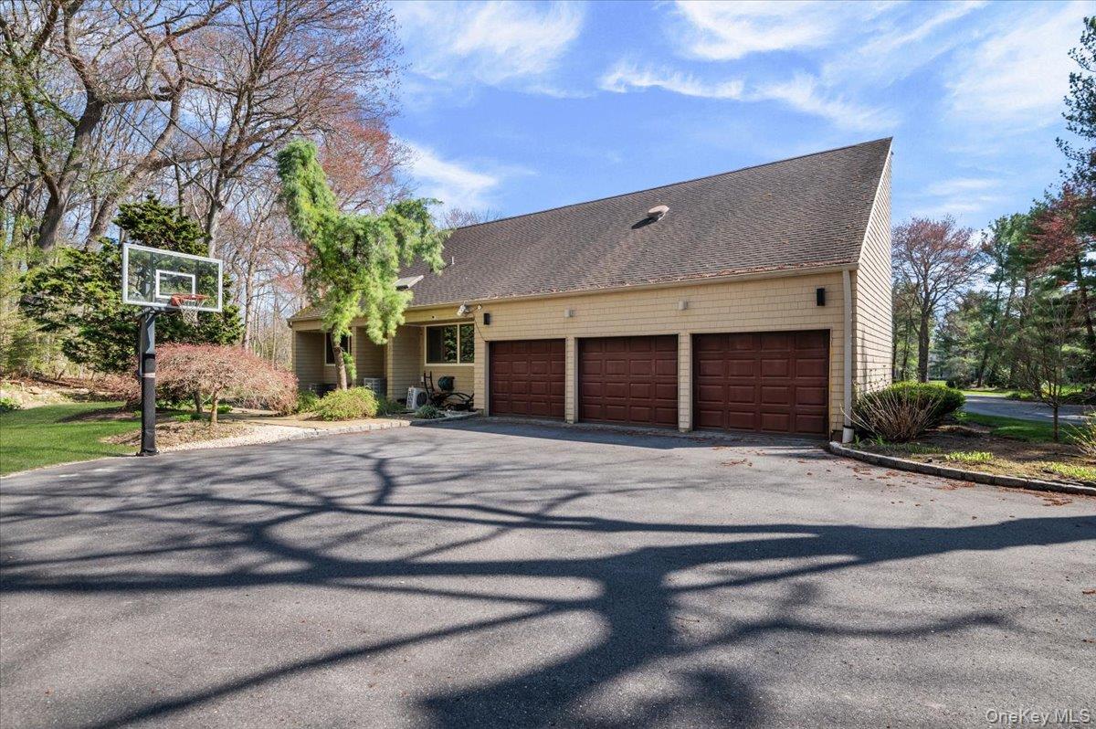 45 Coves Run Syosset, NY 11791 - Photo 42 of 43 a front view of a house with a yard and garage