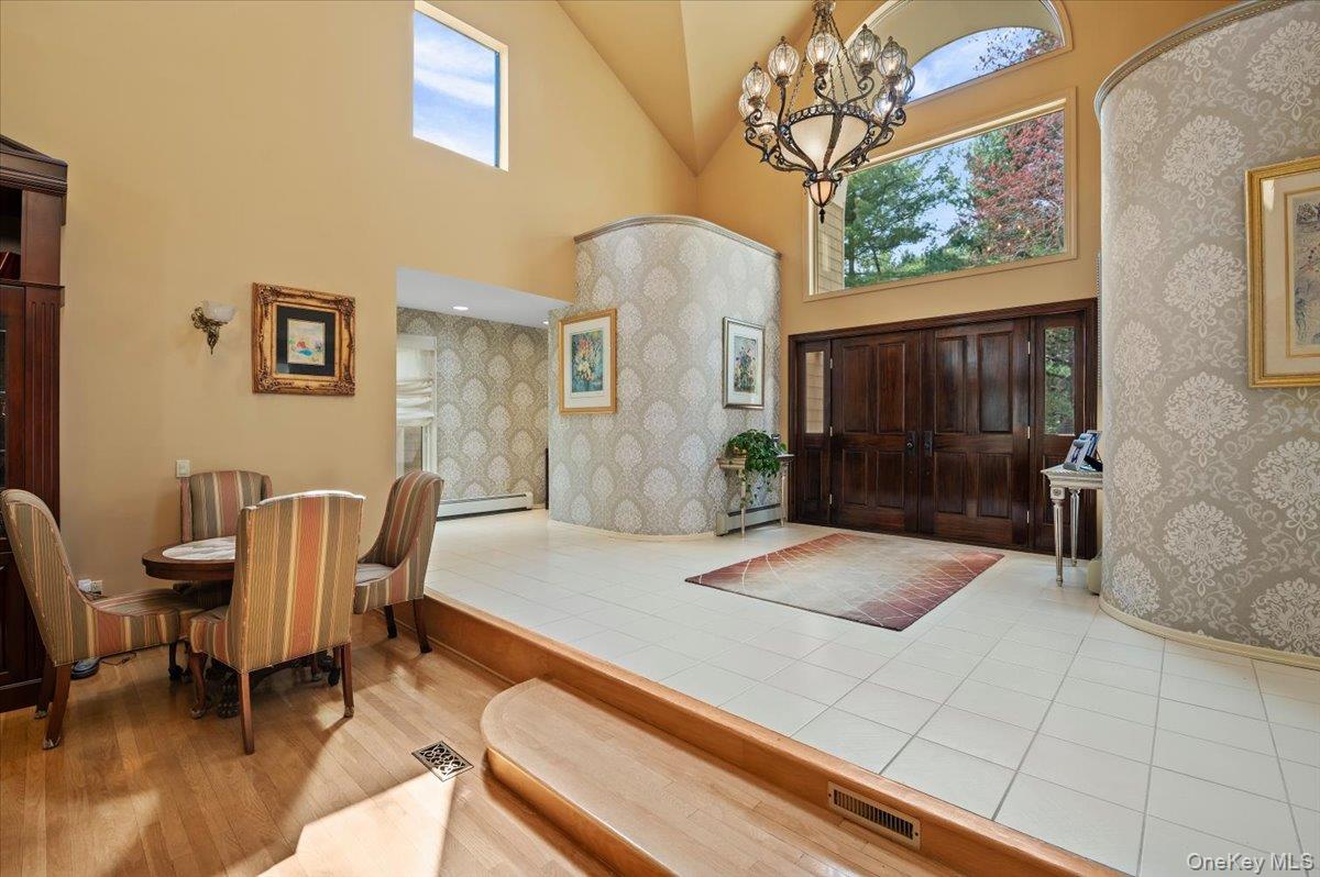 45 Coves Run Syosset, NY 11791 - Photo 5 of 43 a living room with furniture and a floor to ceiling window