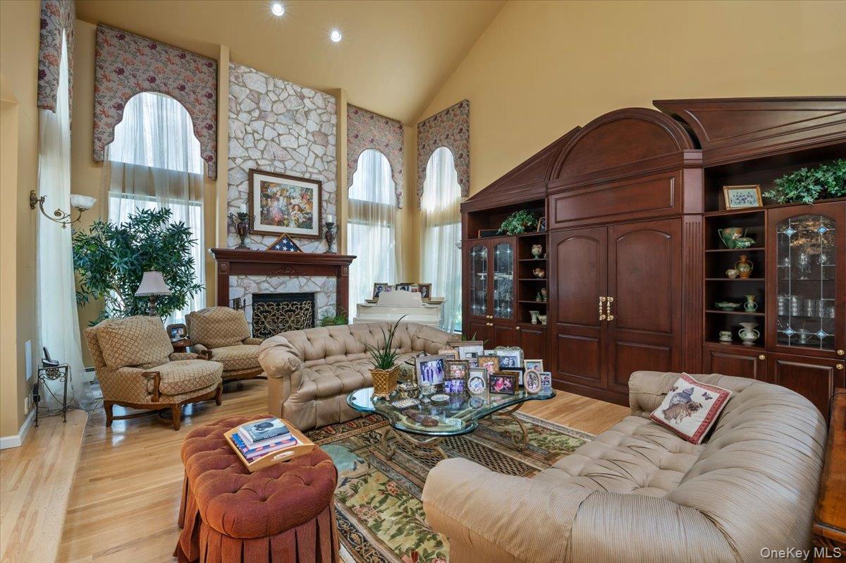 45 Coves Run Syosset, NY 11791 - Photo 7 of 43 a living room with furniture a fireplace and a large window