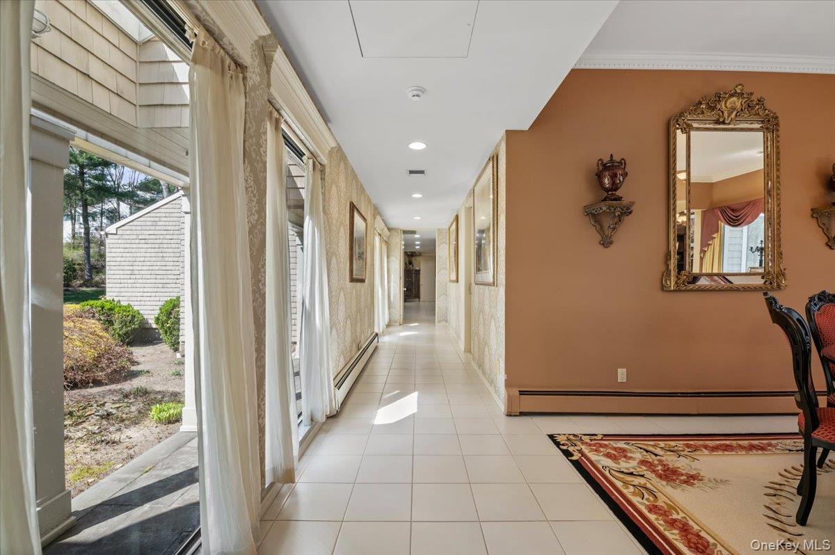 45 Coves Run Syosset, NY 11791 - Photo 10 of 43 a view of a hallway with wooden floor and a living room