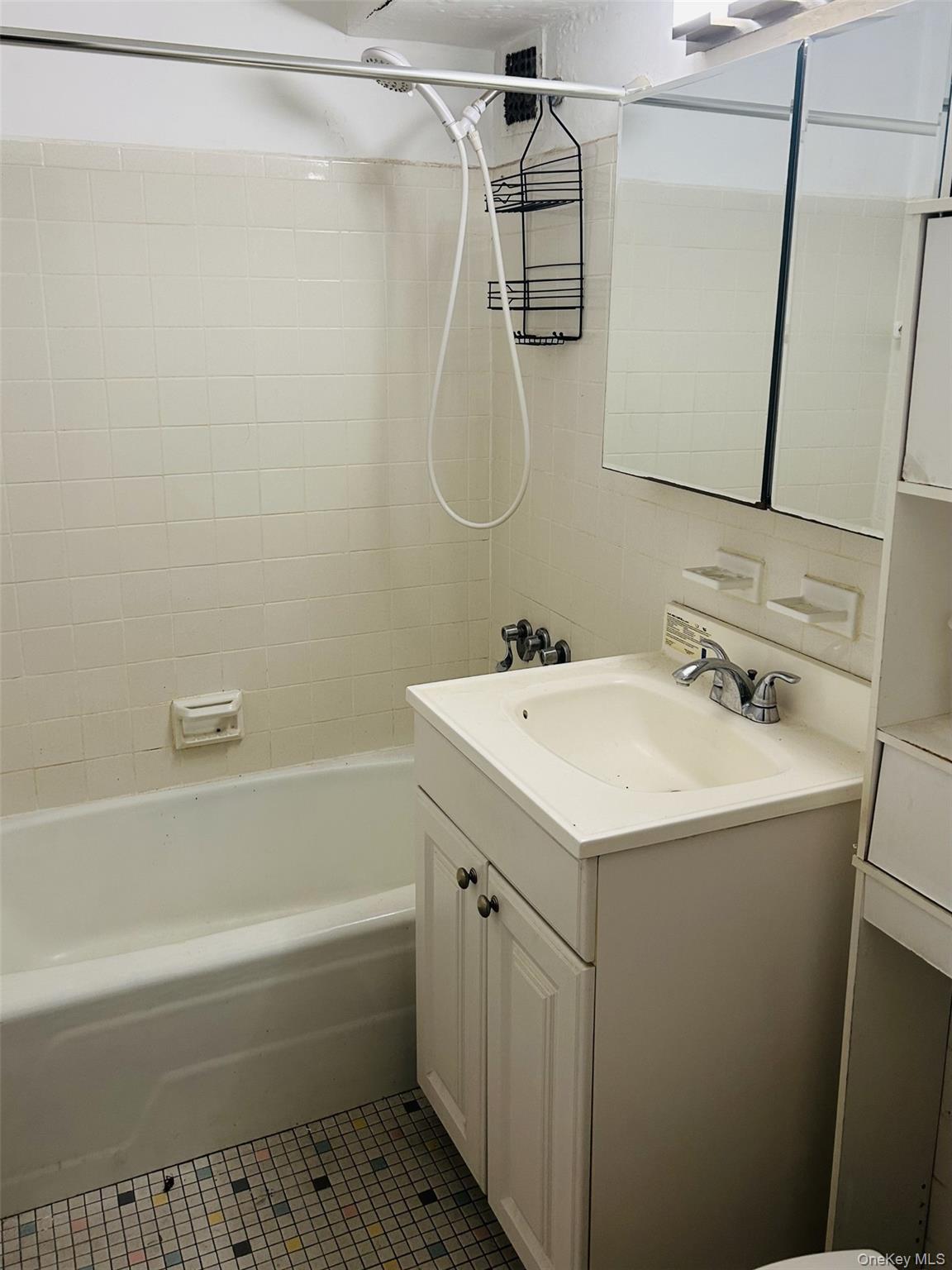 89-00 170th Street, Unit 6G Queens, NY 11432 - Photo 4 of 9 Bathroom with vanity, tub / shower combination, and tile patterned flooring