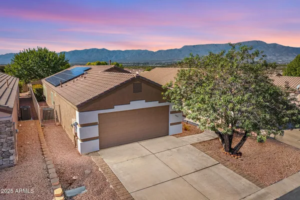 a view of a house with a yard and mountain
