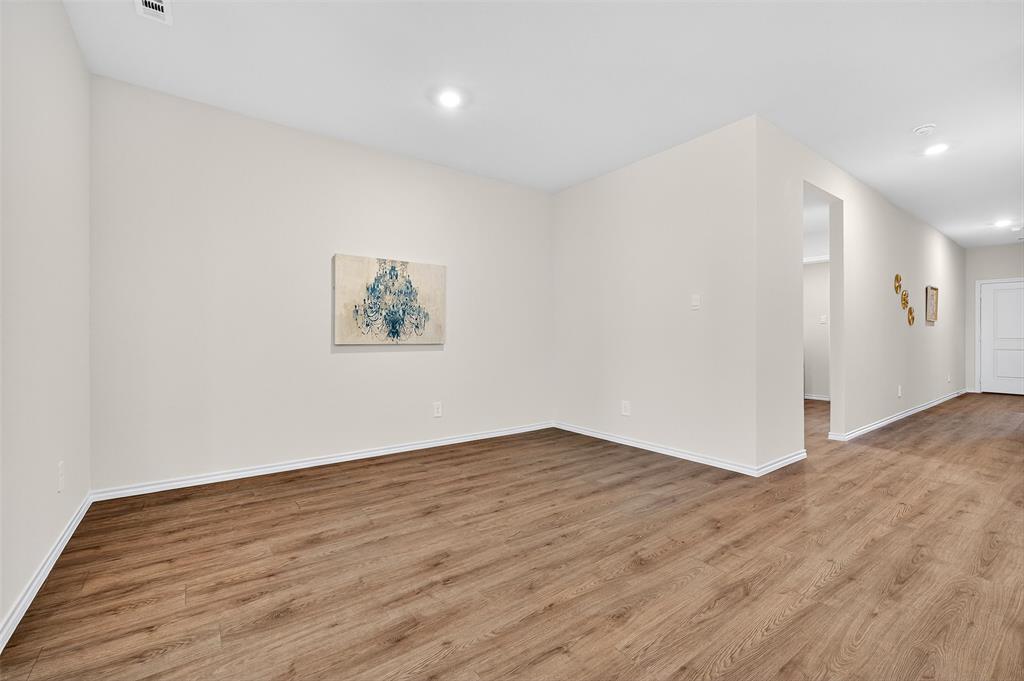 4208 Carnation Drive Sherman, TX 75090 - Photo 13 of 34 a view of an empty room with wooden floor and window