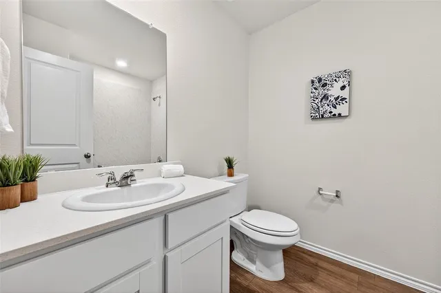 a bathroom with a toilet a sink and mirror