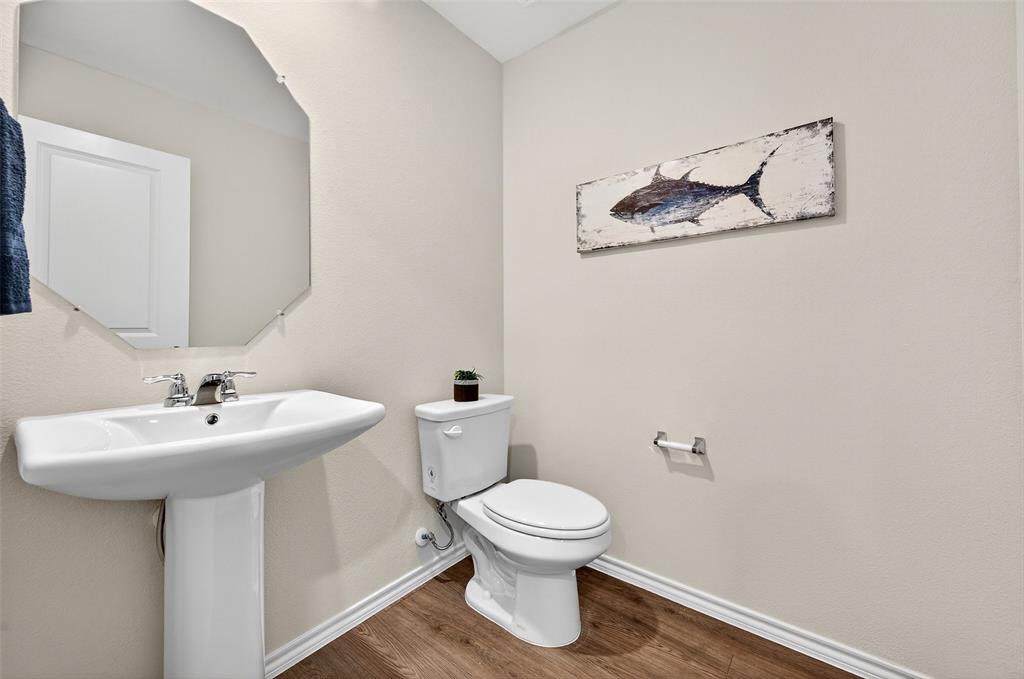 4208 Carnation Drive Sherman, TX 75090 - Photo 28 of 34 a bathroom with a toilet sink and mirror