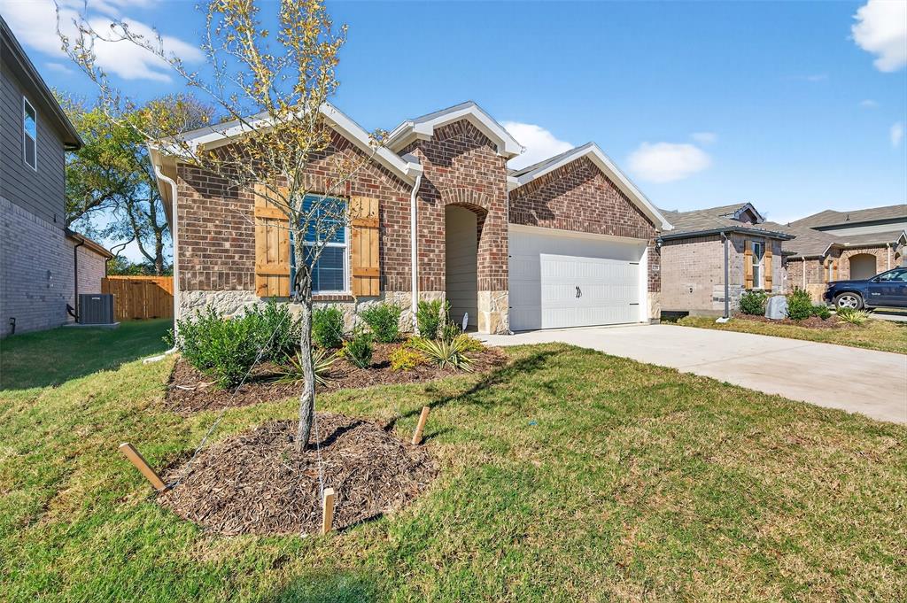 4208 Carnation Drive Sherman, TX 75090 - Photo 3 of 34 a view of a white house next to a yard with potted plants