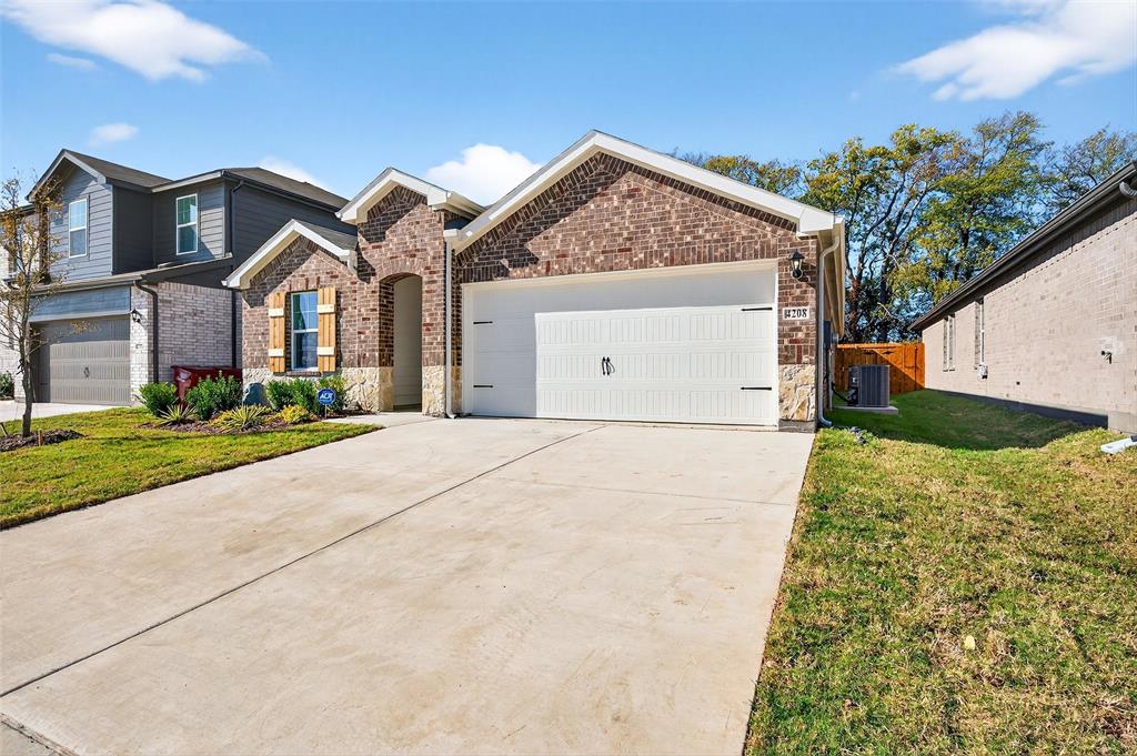 4208 Carnation Drive Sherman, TX 75090 - Photo 4 of 34 a front view of a house with a yard and garage