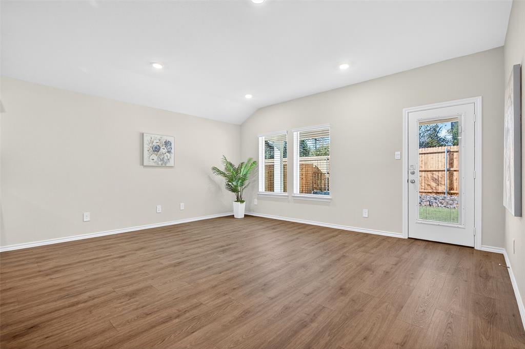 4208 Carnation Drive Sherman, TX 75090 - Photo 5 of 34 a view of an empty room with wooden floor and a window