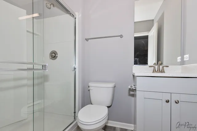 a bathroom with a toilet a sink and shower