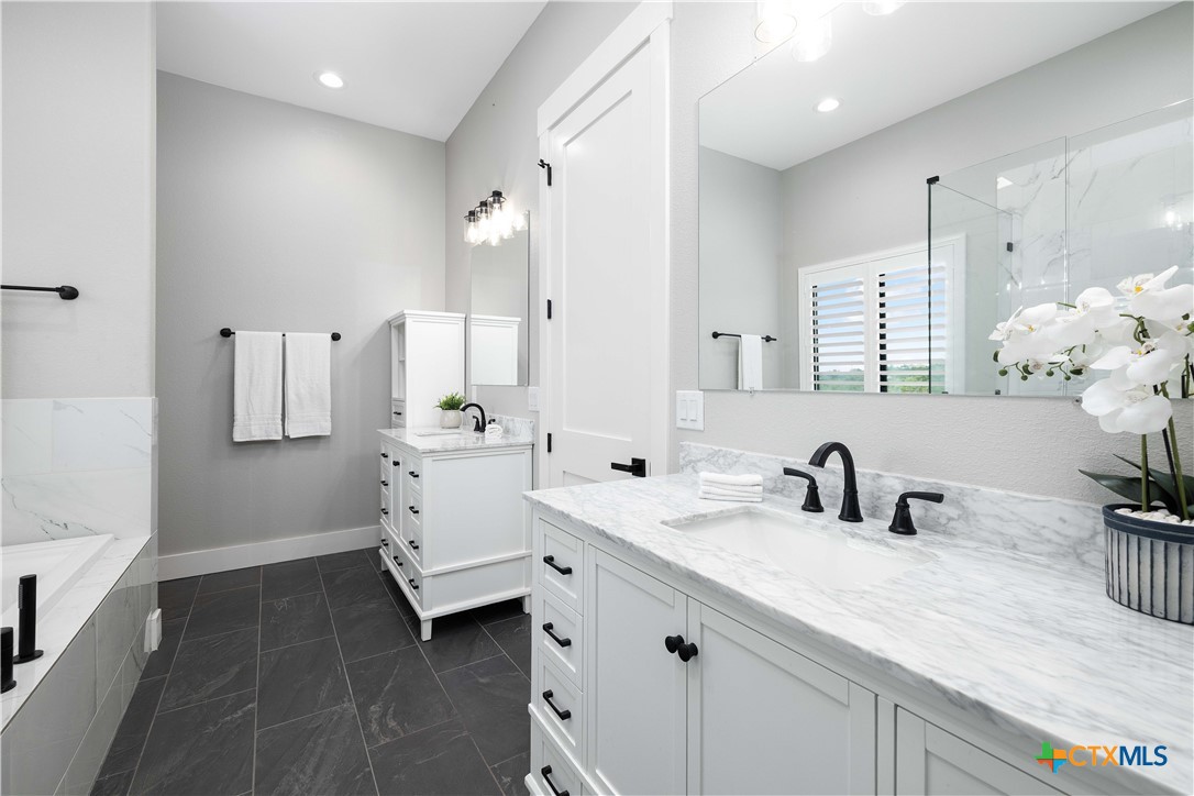 537 Compass Rose Spring Branch, TX 78070 - Photo 15 of 29 a bathroom with double vanity sink a mirror and shower
