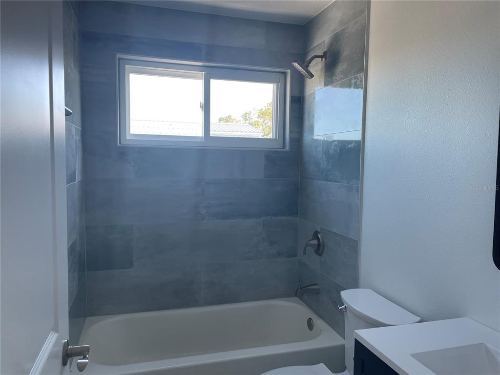 711 Gulf Boulevard Indian Rocks Beach, FL 33785 - Photo 13 of 19 a bath room with a toilet and a bath tub