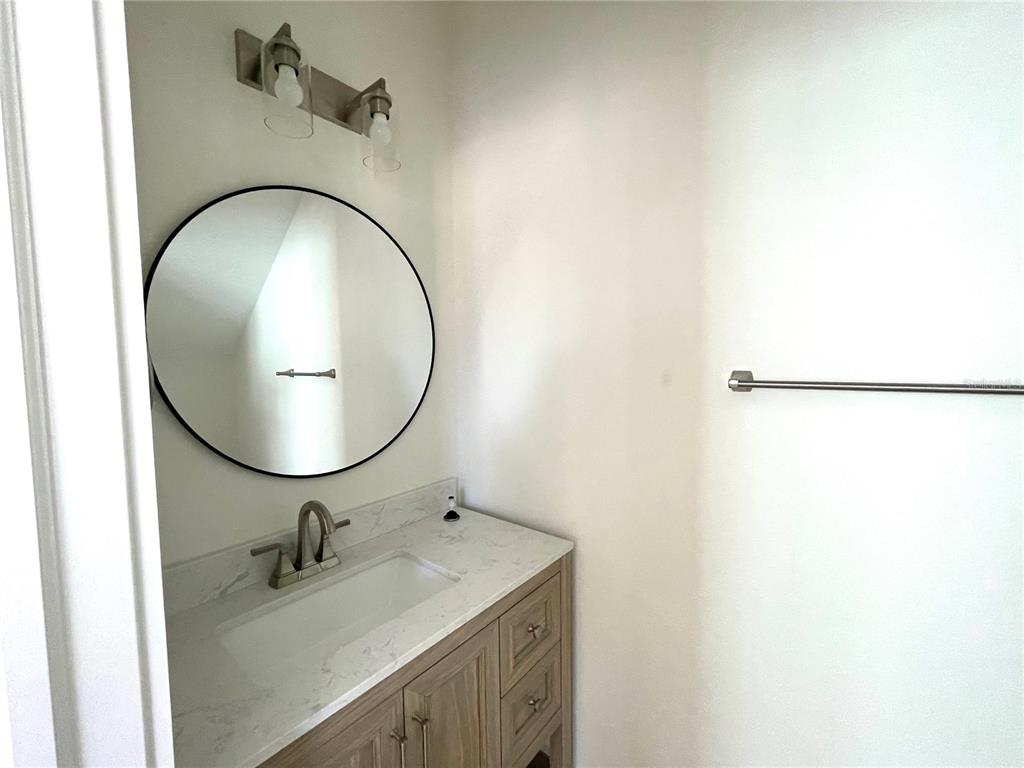 711 Gulf Boulevard Indian Rocks Beach, FL 33785 - Photo 18 of 19 a bathroom with a sink and mirror