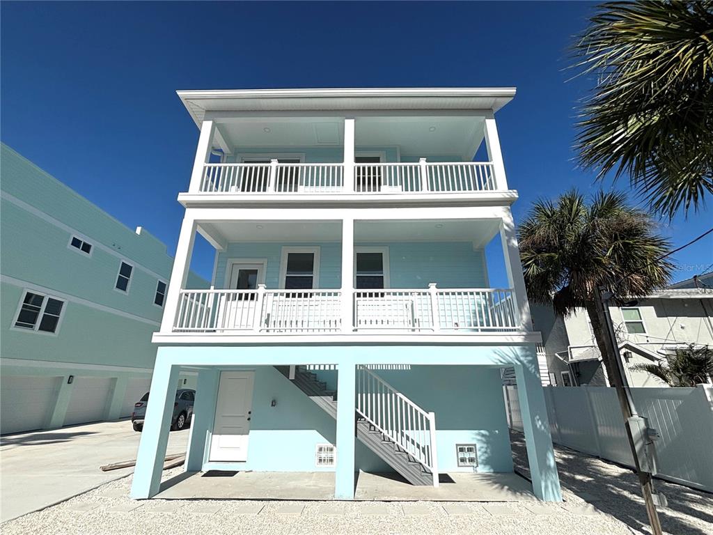 711 Gulf Boulevard Indian Rocks Beach, FL 33785 - Photo 2 of 19 a front view of a house with a yard