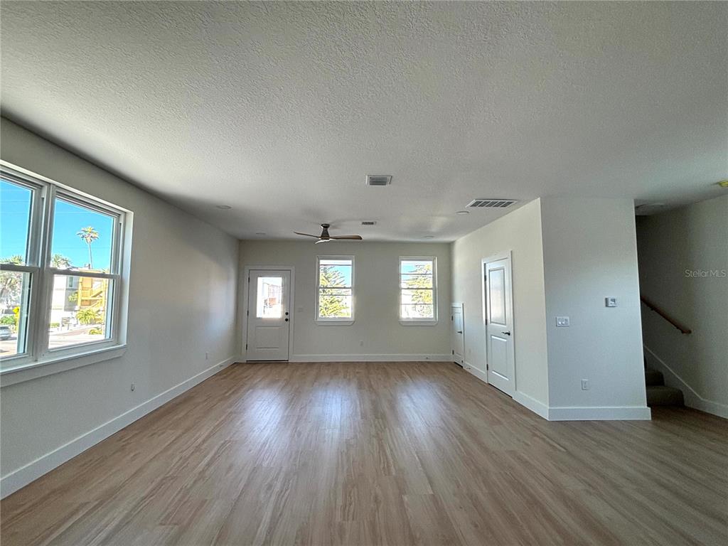 711 Gulf Boulevard Indian Rocks Beach, FL 33785 - Photo 3 of 19 an empty room with wooden floor and windows