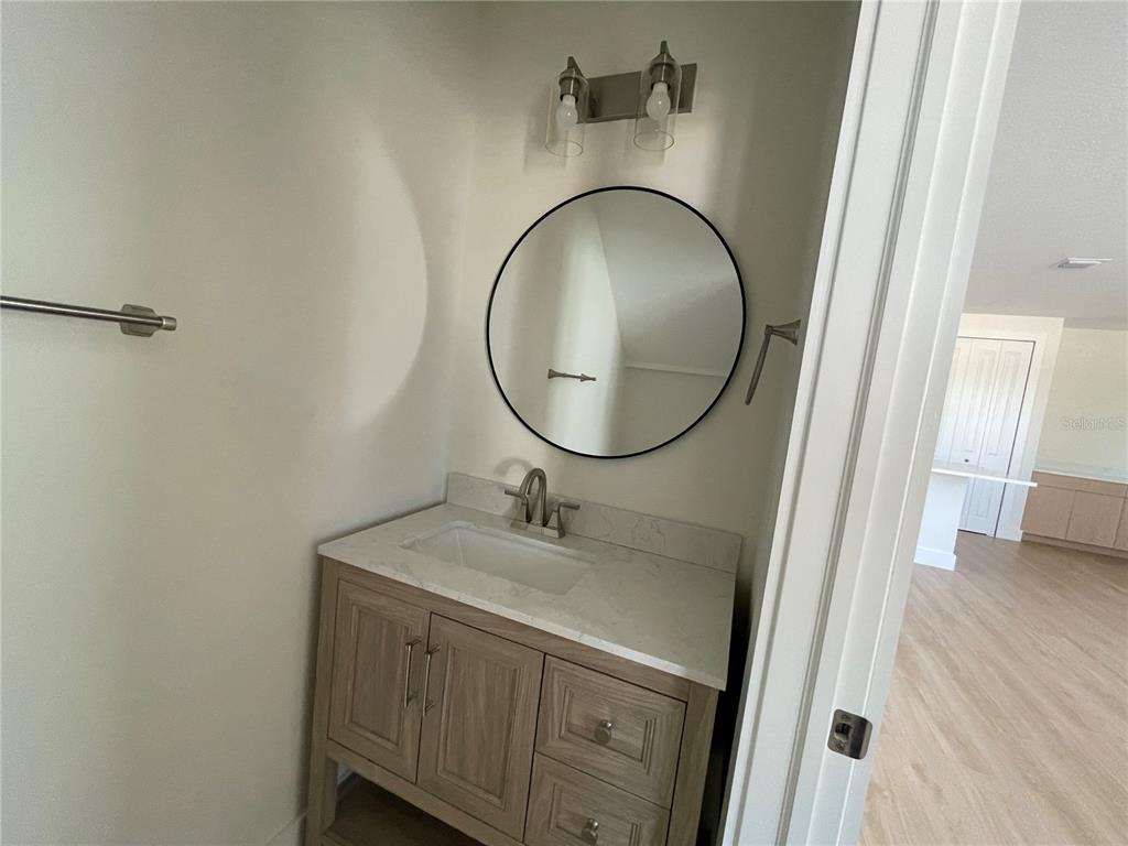 711 Gulf Boulevard Indian Rocks Beach, FL 33785 - Photo 8 of 19 a bathroom with a sink and a mirror