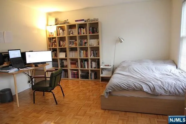 a bedroom with a bed and a bookshelf