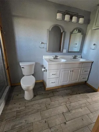 a bathroom with a toilet mirror and vanity