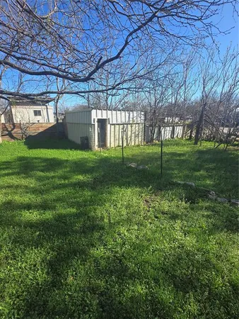 a view of a backyard with porch and garden
