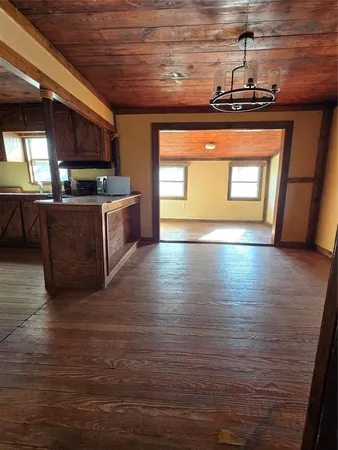 a view of kitchen with stove and cabinets