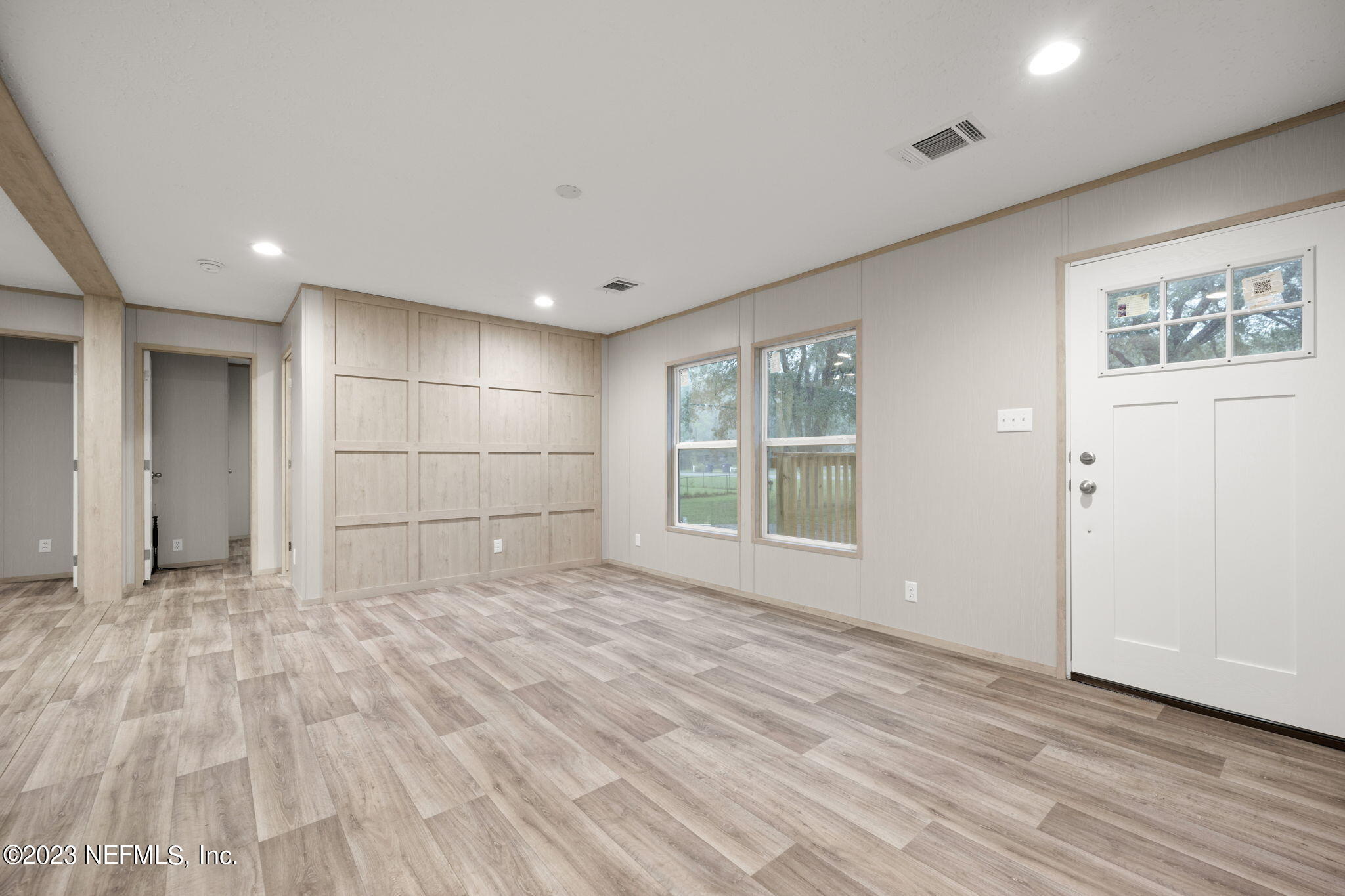 1100 Mulberry Landing Road Hilliard, FL 32046 - Photo 11 of 32 a view of empty room with wooden floor and windows