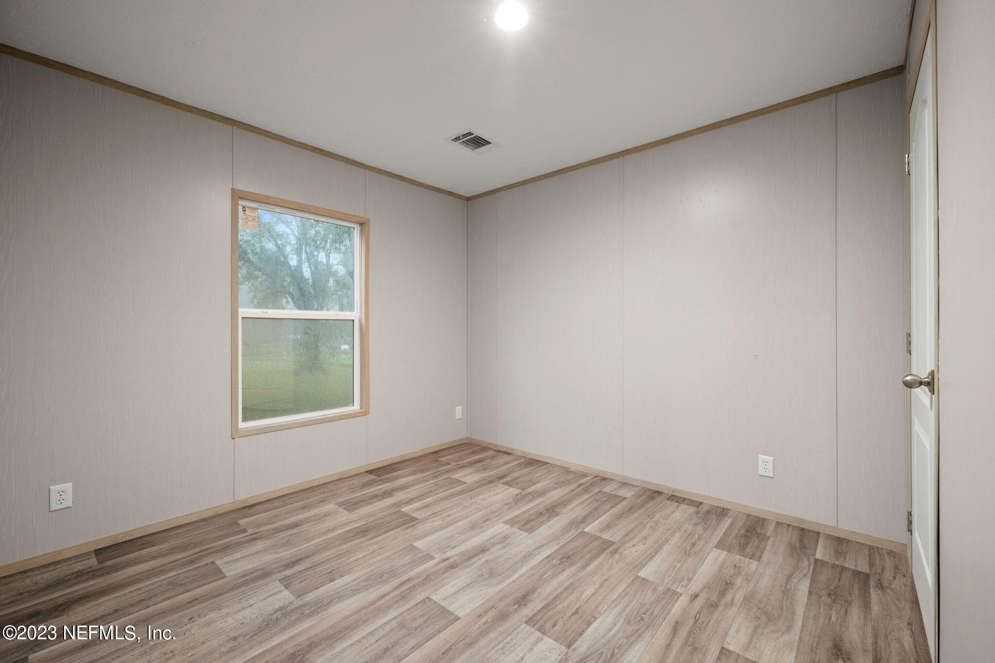 1100 Mulberry Landing Road Hilliard, FL 32046 - Photo 17 of 32 an empty room with wooden floor and windows