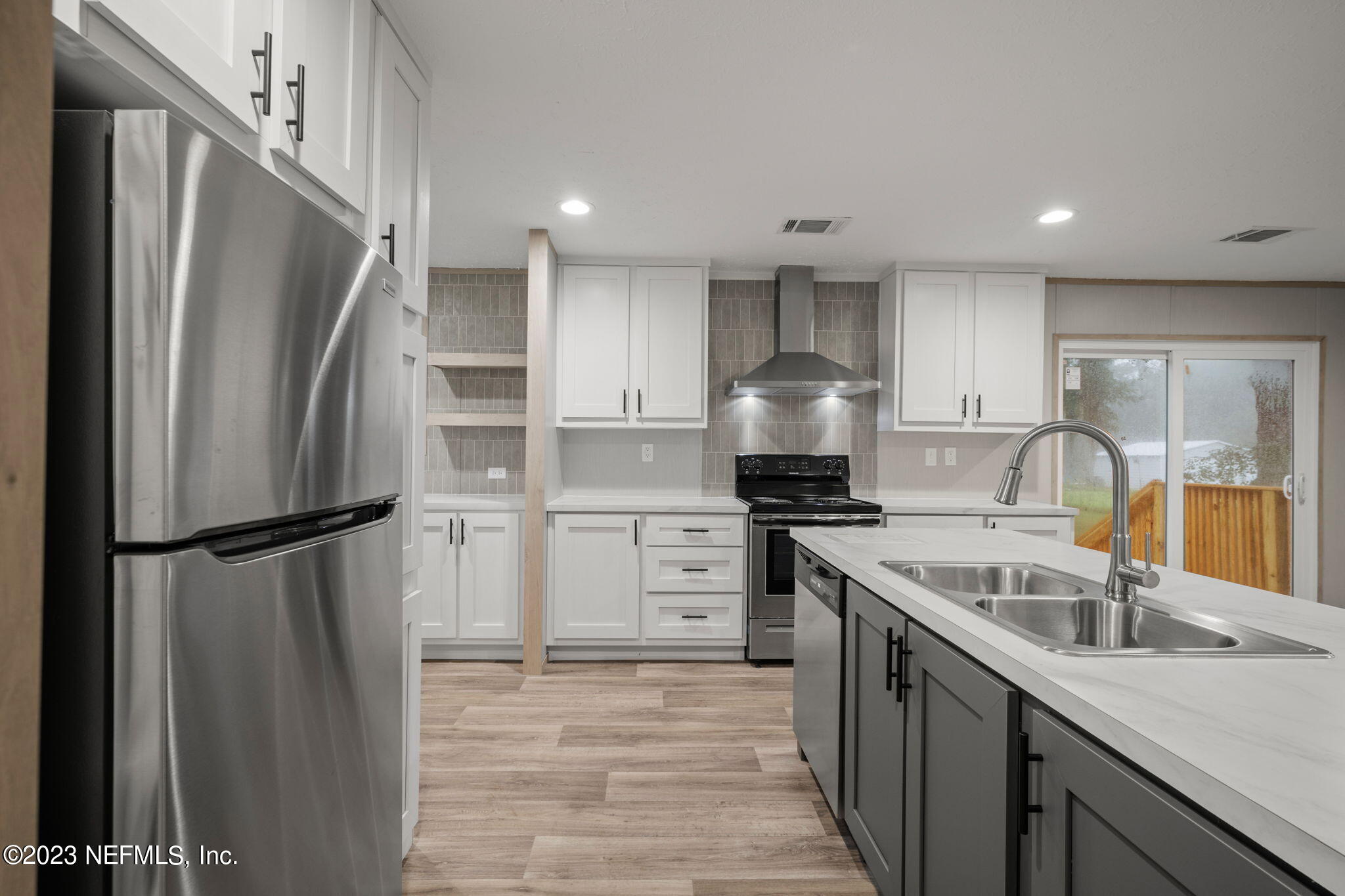 1100 Mulberry Landing Road Hilliard, FL 32046 - Photo 20 of 32 a kitchen with a refrigerator sink stove and refrigerator