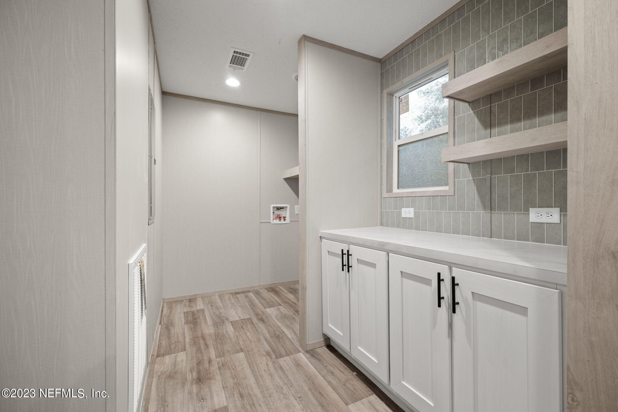 1100 Mulberry Landing Road Hilliard, FL 32046 - Photo 23 of 32 a bathroom with a sink and mirror