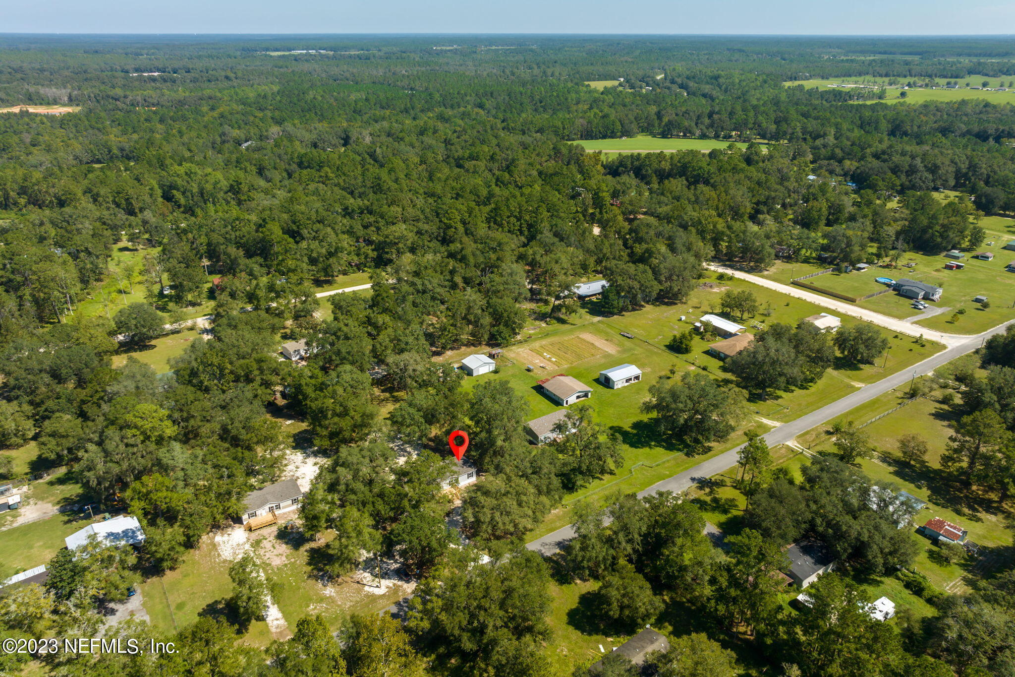 1100 Mulberry Landing Road Hilliard, FL 32046 - Photo 29 of 32 a view of a lush green forest with trees and houses