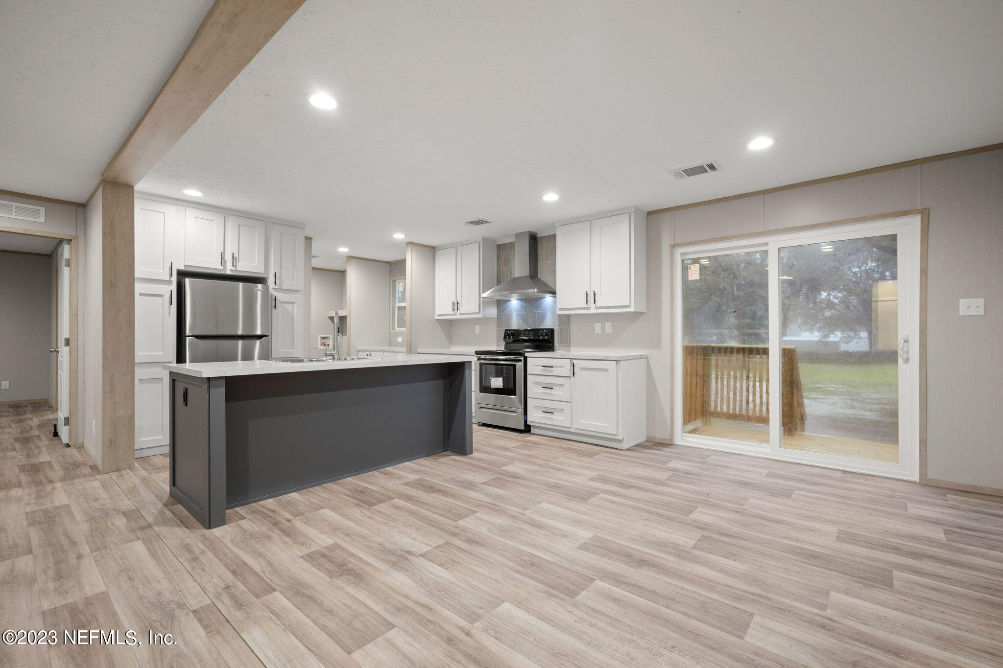 1100 Mulberry Landing Road Hilliard, FL 32046 - Photo 3 of 32 a kitchen with stainless steel appliances granite countertop a refrigerator sink and cabinets
