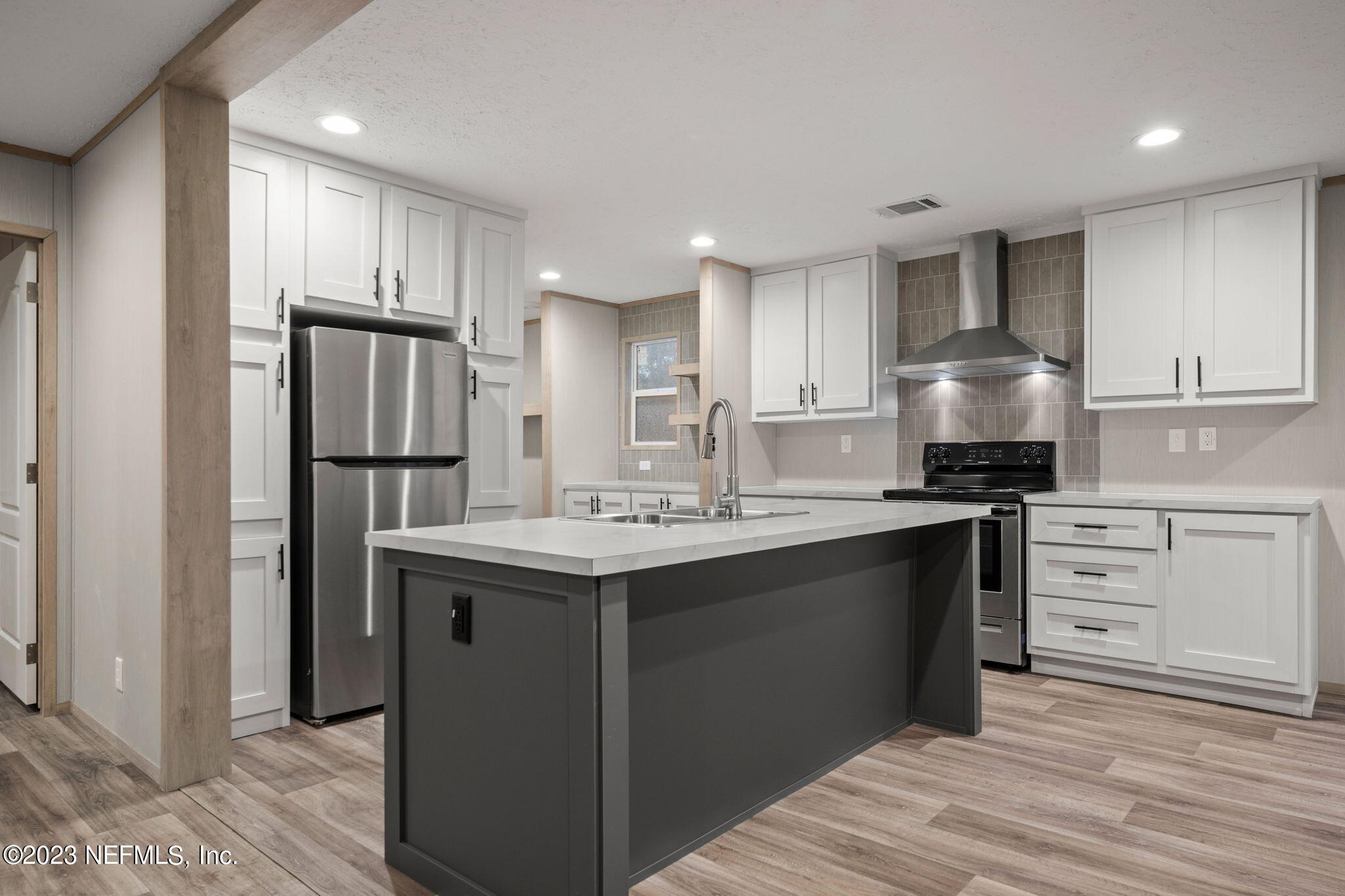 1100 Mulberry Landing Road Hilliard, FL 32046 - Photo 4 of 32 a kitchen with kitchen island granite countertop appliances cabinets and a sink
