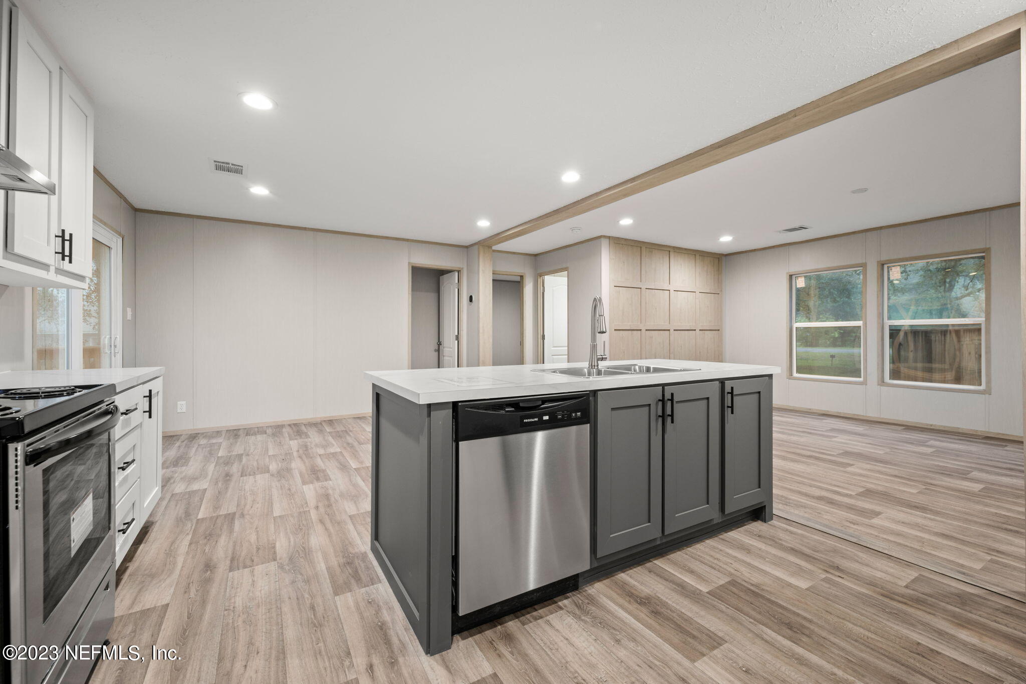 1100 Mulberry Landing Road Hilliard, FL 32046 - Photo 6 of 32 a kitchen with stainless steel appliances granite countertop a stove a sink and a wooden floors