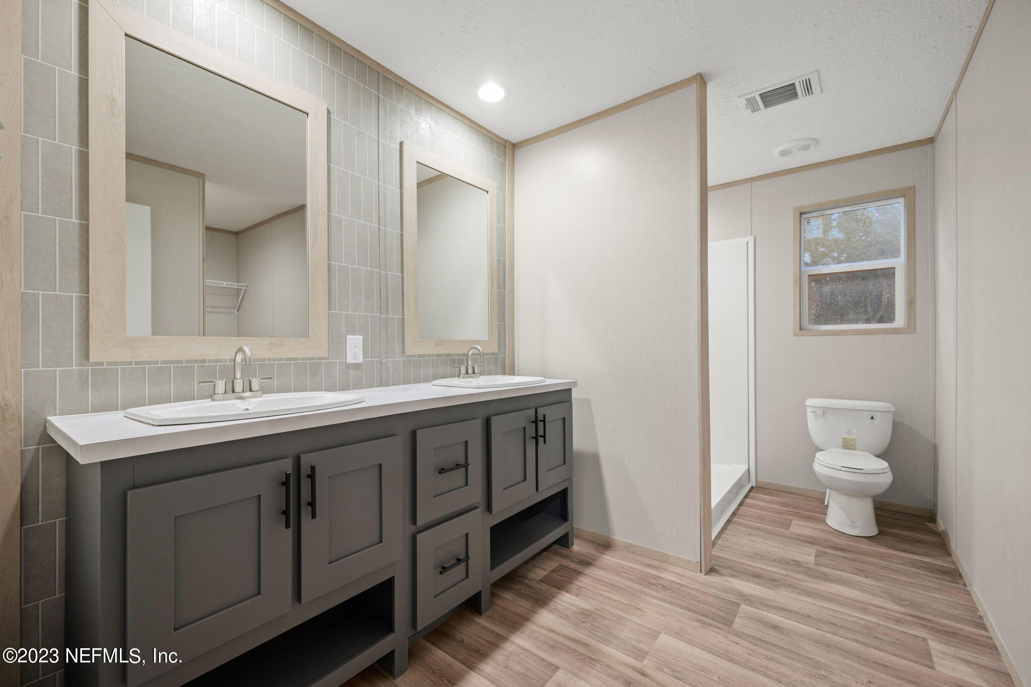 1100 Mulberry Landing Road Hilliard, FL 32046 - Photo 7 of 32 a spacious bathroom with a double vanity sink mirror and toilet