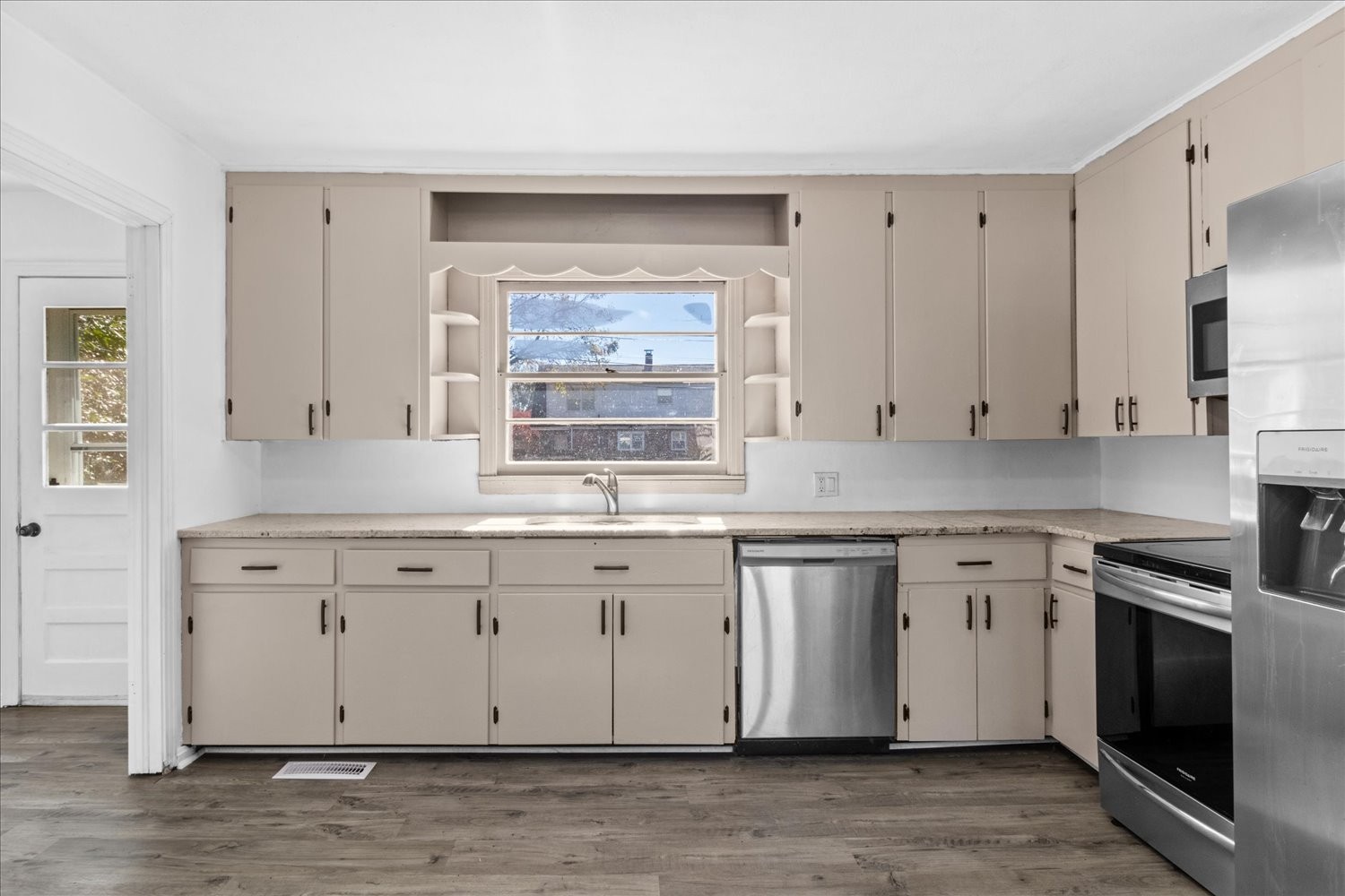 603 3rd Street Lawrenceburg, TN 38464 - Photo 3 of 11 a kitchen with granite countertop white cabinets stainless steel appliances a sink and a window