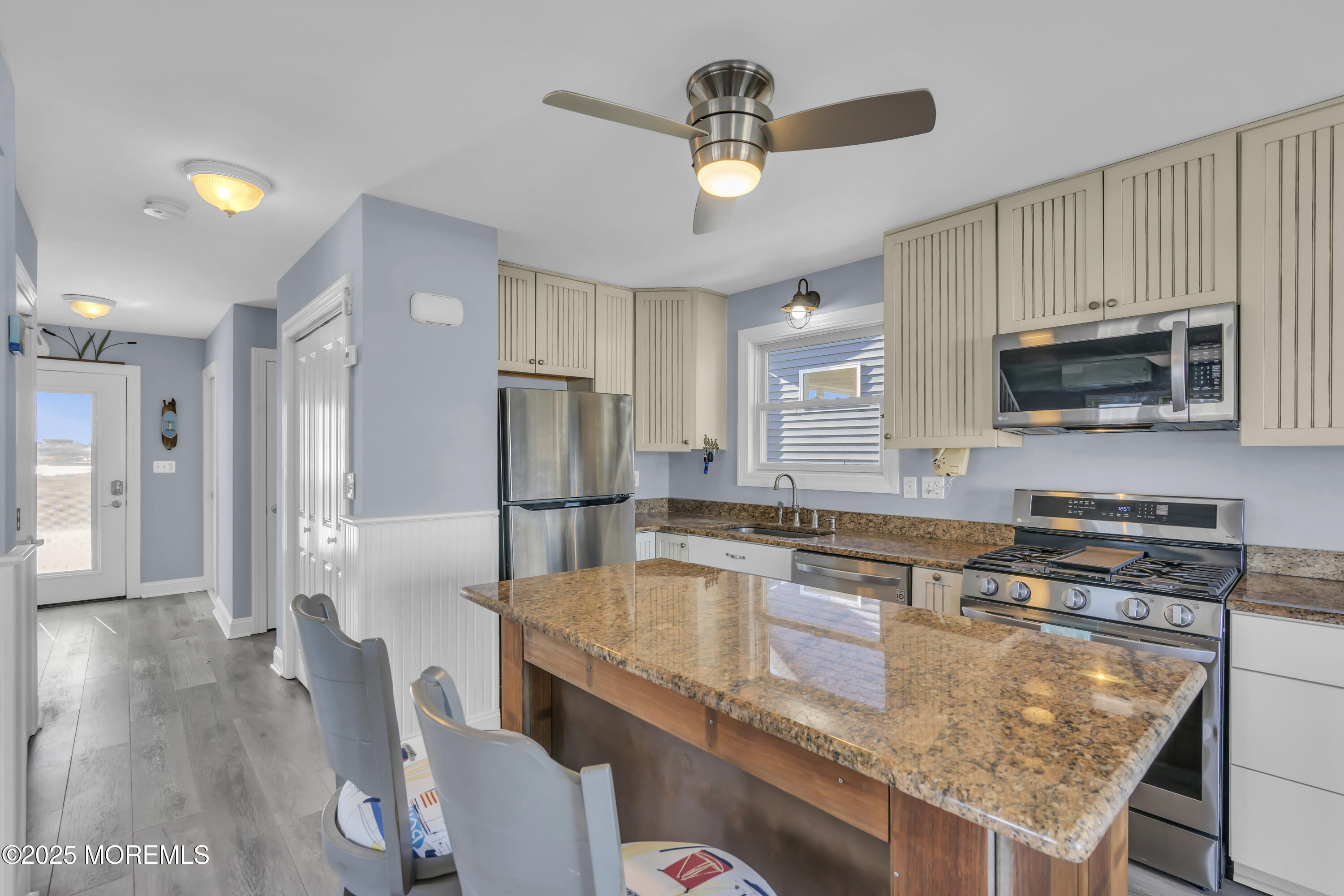 132 St Lawrence Boulevard Brick, NJ 08723 - Photo 13 of 55 a kitchen with stainless steel appliances granite countertop a sink a stove a refrigerator cabinets and chairs