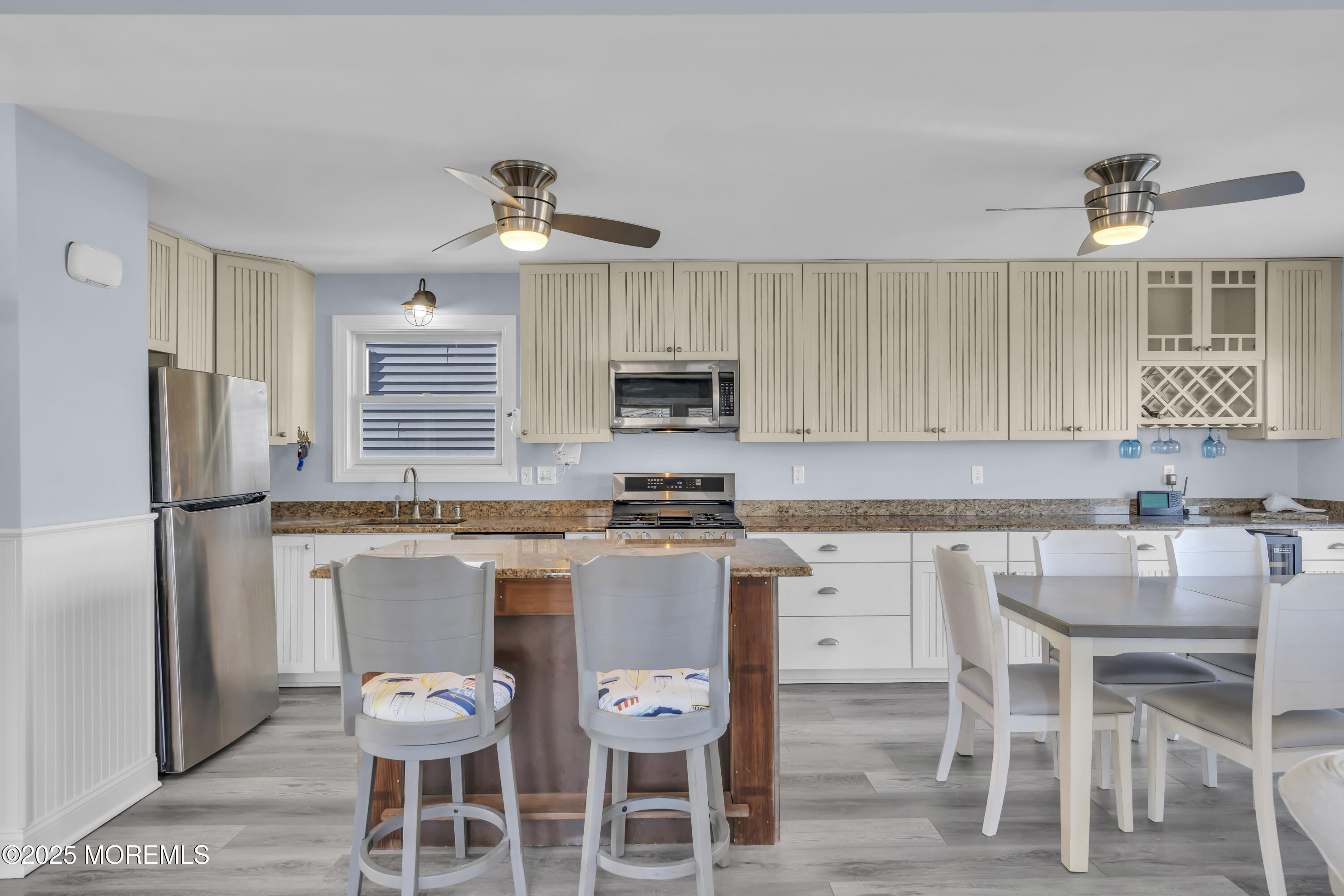 132 St Lawrence Boulevard Brick, NJ 08723 - Photo 16 of 55 a kitchen with a dining table chairs refrigerator and microwave