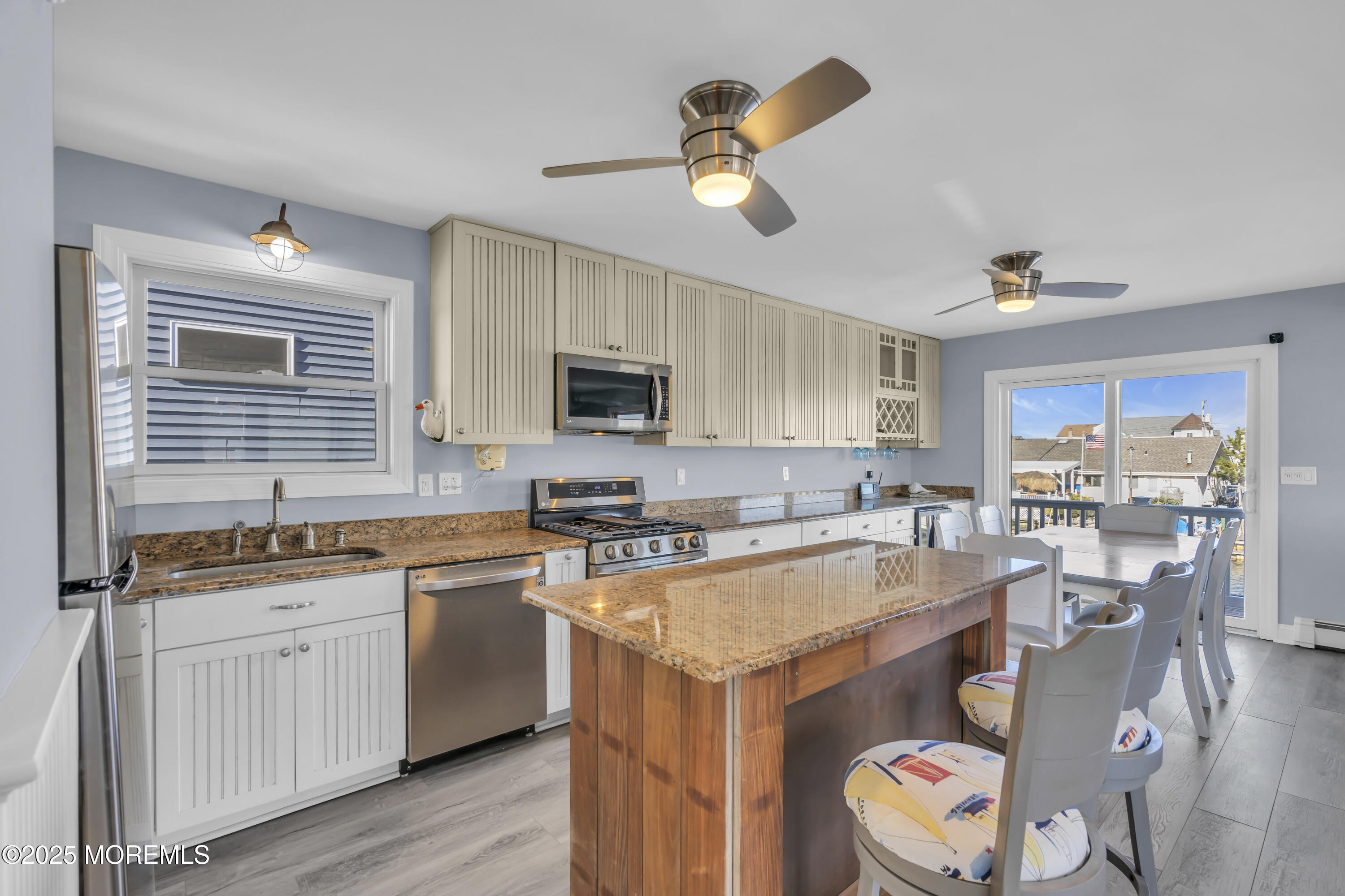 132 St Lawrence Boulevard Brick, NJ 08723 - Photo 9 of 55 a kitchen with a sink a stove cabinets and wooden floor