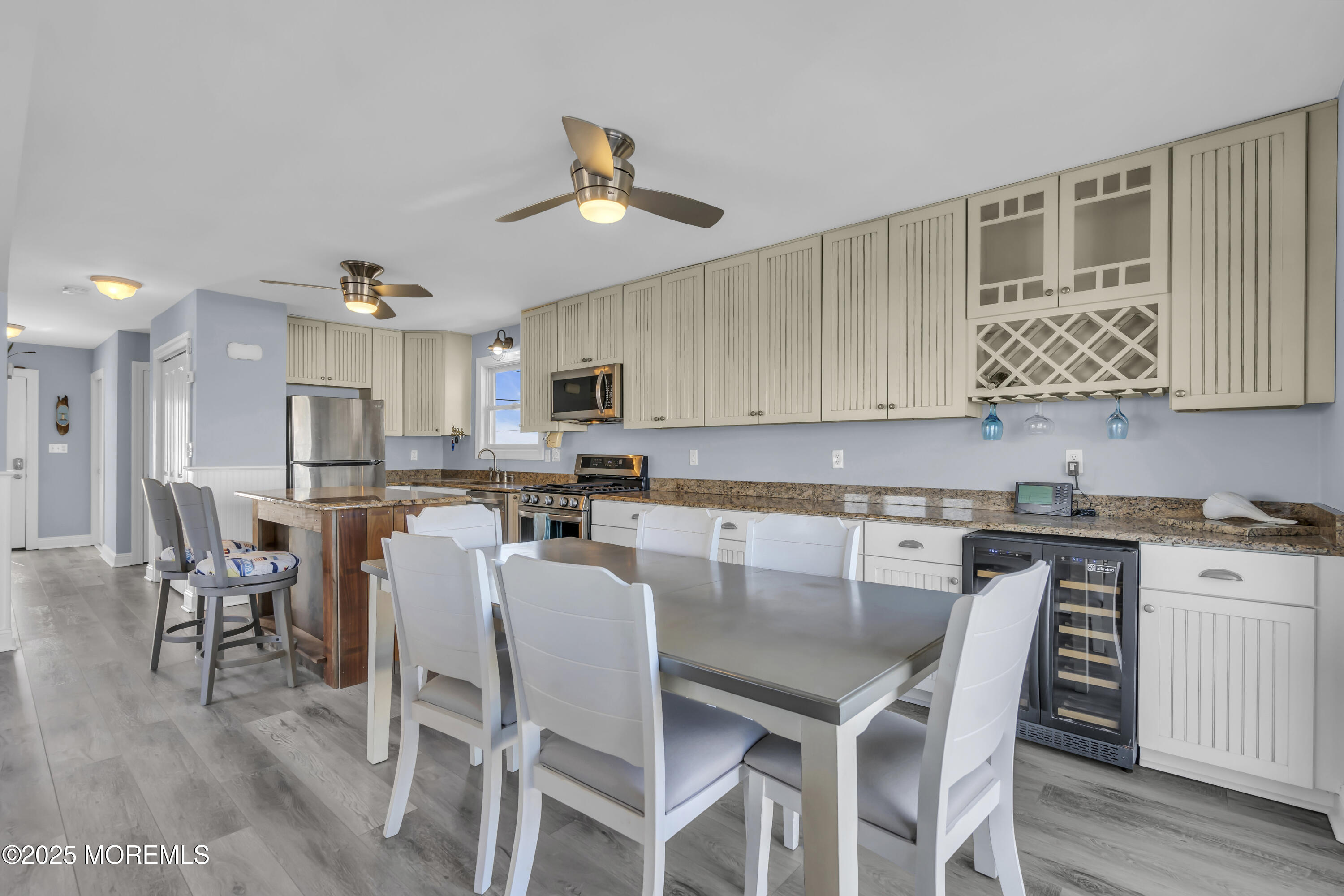 132 St Lawrence Boulevard Brick, NJ 08723 - Photo 10 of 55 a kitchen with stainless steel appliances kitchen island granite countertop a dining table chairs and white cabinets