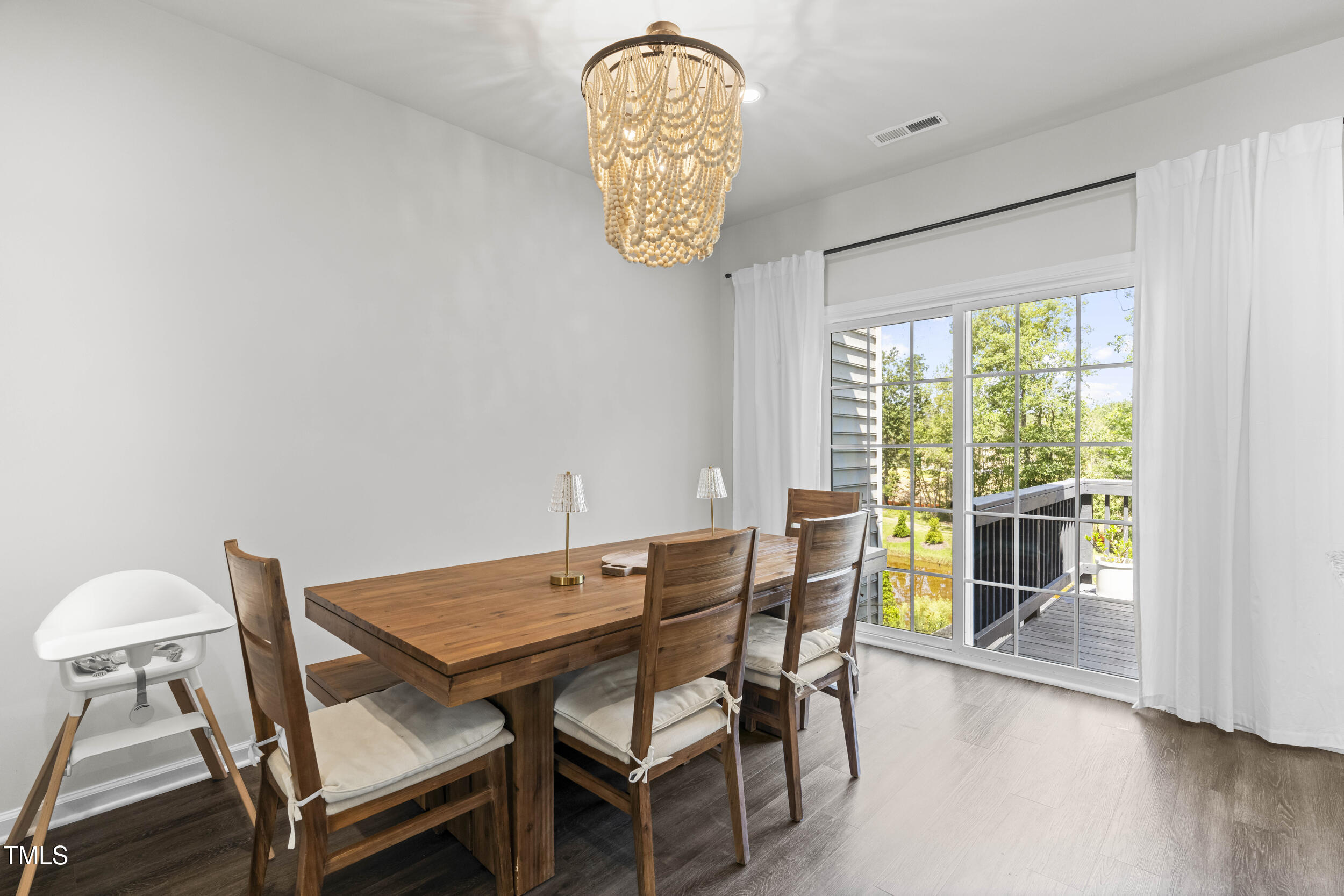 6607 Pathfinder Way Raleigh, NC 27616 - Photo 13 of 38 a view of a dining room with furniture and wooden floor