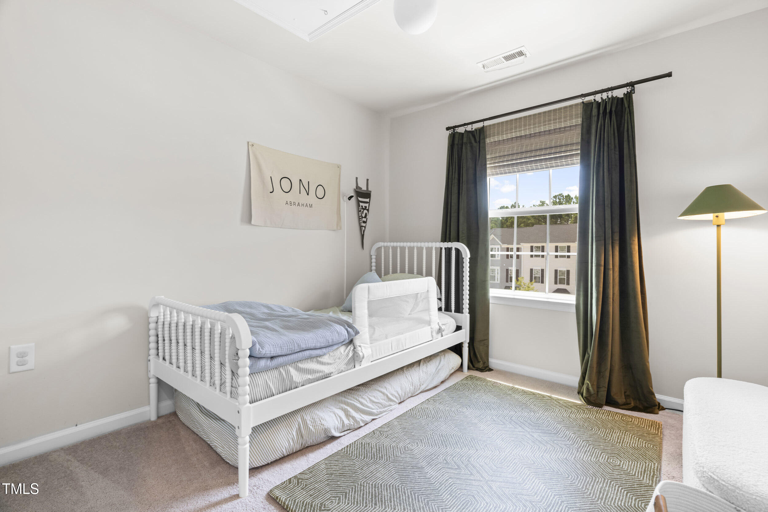 6607 Pathfinder Way Raleigh, NC 27616 - Photo 27 of 38 a bedroom with a bed and a window