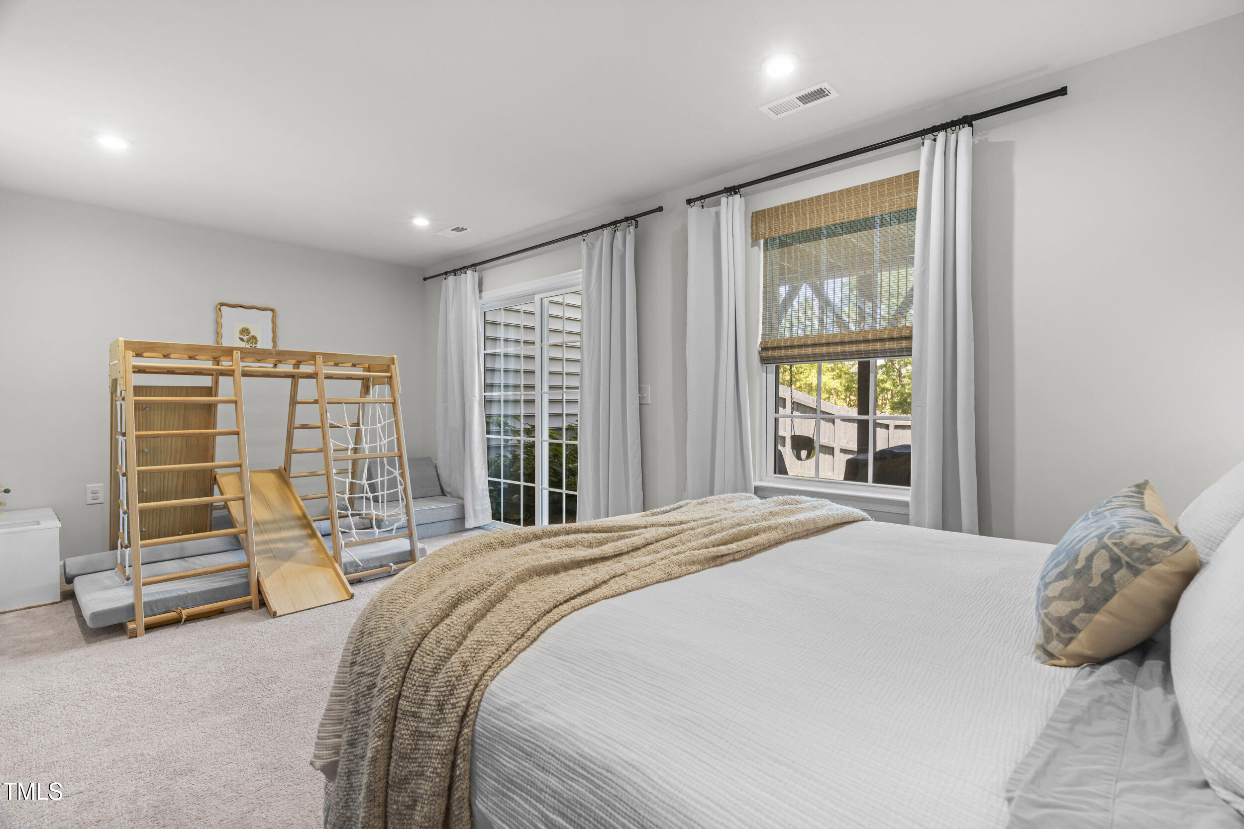 6607 Pathfinder Way Raleigh, NC 27616 - Photo 7 of 38 a bed sitting in a spacious bedroom next to a window