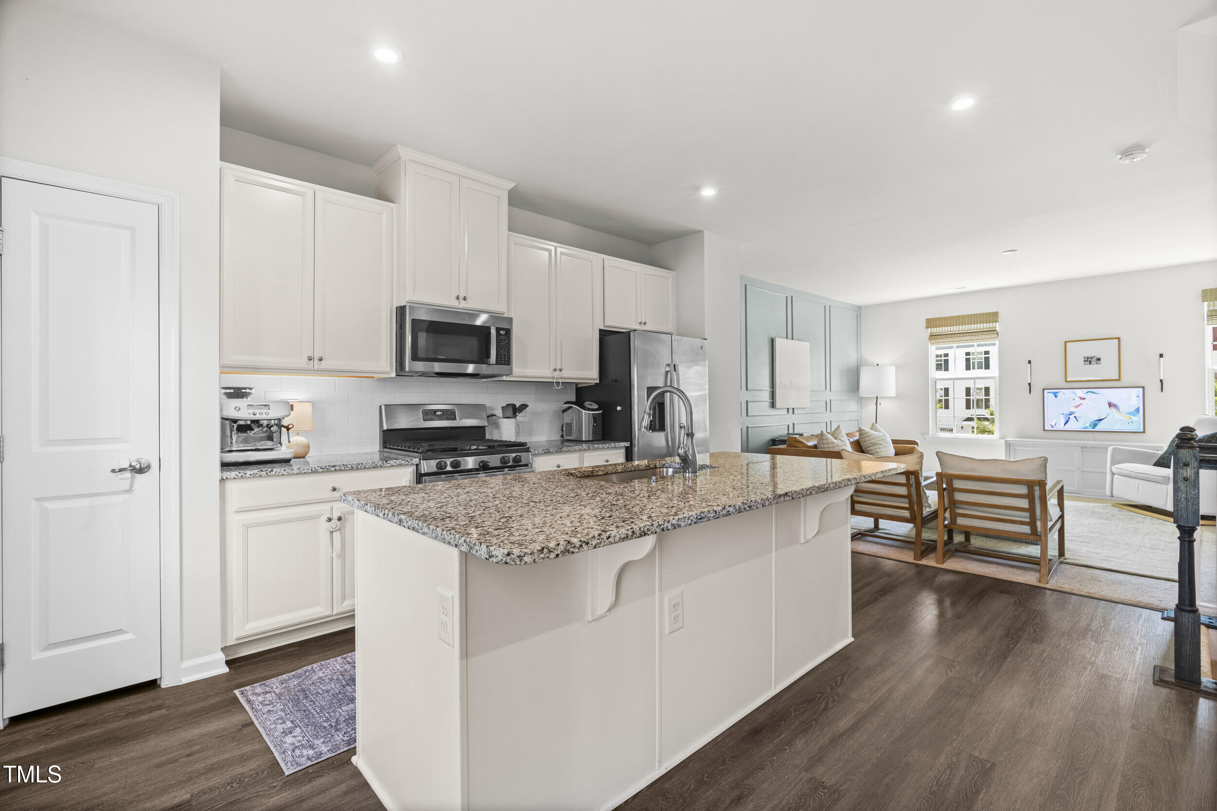 6607 Pathfinder Way Raleigh, NC 27616 - Photo 9 of 38 a kitchen with stainless steel appliances granite countertop a stove top oven a sink dishwasher and a refrigerator with wooden floor