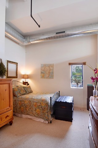1224 West Van Buren Street, Unit 213 Chicago, IL 60607 - Photo 13 of 16 a bedroom with a bed and a window