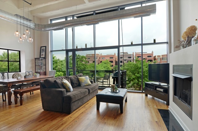 1224 West Van Buren Street, Unit 213 Chicago, IL 60607 - Photo 3 of 16 a living room with furniture tv and a large window