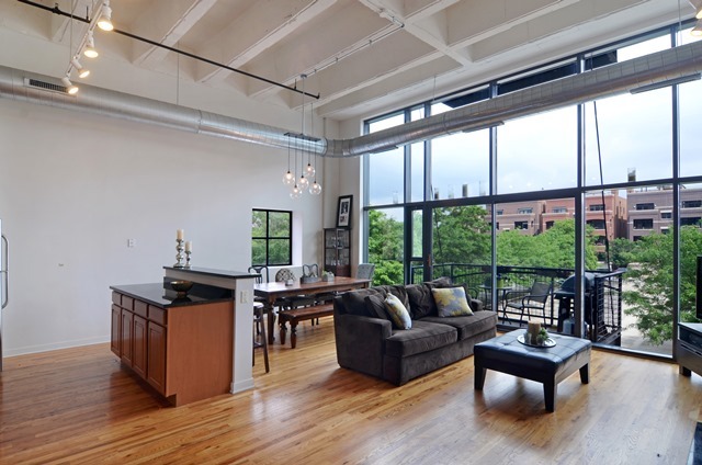1224 West Van Buren Street, Unit 213 Chicago, IL 60607 - Photo 4 of 16 a living room with furniture windows and wooden floor
