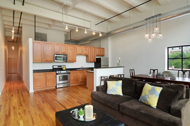 1224 West Van Buren Street, Unit 213 Chicago, IL 60607 - Photo 6 of 16 a living room with stainless steel appliances furniture and a kitchen view