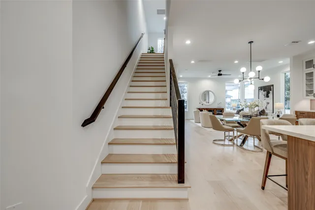a view of a hallway with dining room and workspace