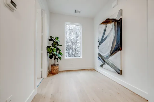 a bedroom with a large bed and a large window