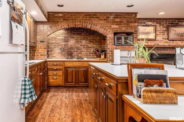 a kitchen with stainless steel appliances granite countertop a stove a sink dishwasher and a refrigerator