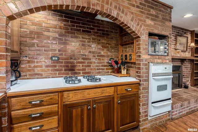 a bed sitting in a spacious bedroom next to a window