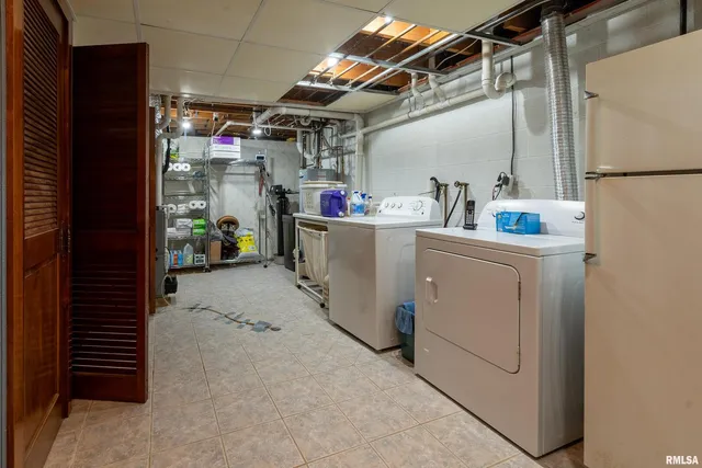 a view of walk in closet with clothes